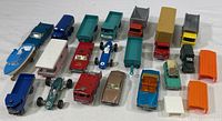 Full set of 20 die cast vehicles in varied types and colors arranged in rows. Includes cars, trucks, trailers, and specialty vehicles with paint wear and rust spots visible.