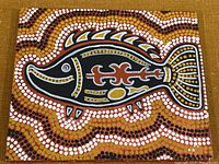 Close-up of the Indigenous dot painting showing detailed fish depiction and dot patterns.