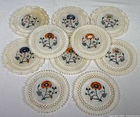 Full group of 10 marble inlay plates showing floral designs and carved borders.