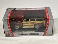 Photo of 1948 Ford Woody die-cast car in original packaging showing the model inside box.