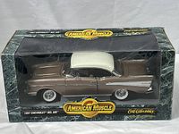 Front side view of 1957 Chevrolet Bel Air die cast model inside original box with clear window and American Muscle branding.