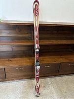 Front view of skis standing showing graphics and bindings