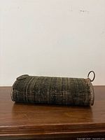 Side view of cylindrical foot warmer showing fabric exterior