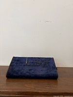 Front view showing blue velvet exterior and handle