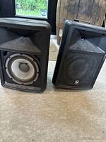 Front view of both Sx80 speakers, one grille removed