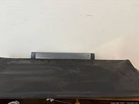 Front view showing console partially under black cover