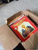 Open box showing Sesame Street Treasury LP on top of stack