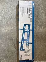 Front of boxed Nexxtech fixed TV mount showing branding and specifications