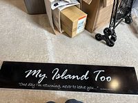 Front of black plastic sign showing text