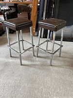 Full view of both bar stools showing design and condition