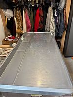 Full view of grey plastic shelf on top of appliances