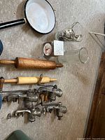 Lot overview showing grinders, rolling pins, pan, glass vases, scale, cookie cutters