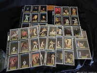 Full view of 40 Elvis Presley trading cards arranged in protective plastic sleeves showing multiple images of Elvis in various outfits and poses.