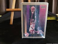 Close-up photo of front of single basketball card featuring player John Battle from 1990 SkyBox set.