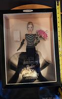 Barbie doll in original display box dressed in black and silver with pink flower bouquet, showing 40th Anniversary text on box.
