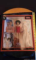 Original boxed Barbie 50th Anniversary doll from 1962 Brunette Bubble Cut edition with accessories and booklet visible