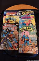 Six Superman and Superboy DC Comics laid out showing colorful front covers with various characters and titles.