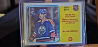 Front of 1982-83 OPC Wayne Gretzky hockey card #235 showing Gretzky in Edmonton Oilers uniform, 1981-82 NHL goal leader info.