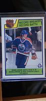 Front of 1983-84 O-Pee-Chee Wayne Gretzky hockey card #212 with record breaker title and NHL logo