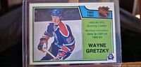 Front of the 1983-84 OPC Wayne Gretzky hockey card showing player image, NHL logo, scoring leader text