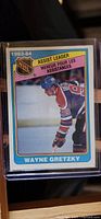 Front of 1983-84 O-Pee-Chee Wayne Gretzky hockey card #382 showing player image and Assist Leader designation
