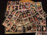 Photo showing an assortment of WWF 1985 wrestling trading cards spread out with clear images of wrestlers and action shots.
