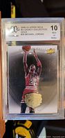 Front of Michael Jordan graded trading card showing player in Chicago Bulls jersey shooting a basketball, with grading label at top indicating 10 Mint or Better.