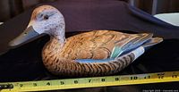 Front and side view of hand carved vintage blue wing teal decoy showing detailed paint and feather pattern with tape measure indicating size near 11 inches.