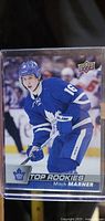 Front of the Mitch Marner rookie card showing the player in full Toronto Maple Leafs blue uniform with number 16, labeled 'Top Rookies' and featuring Upper Deck logo.