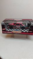 Photo of the boxed American Muscle 1:18 Fingerhut Thunderbird #98 die-cast model car showing packaging and car inside box.