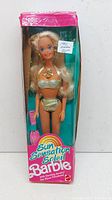 Front view of unopened Mattel Barbie Doll 1390 in original box featuring the doll in a gold swimsuit with matching accessories.