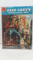 Front cover of the comic book showing cowboy with rifle and Western scene