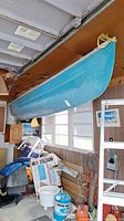 Canoe hung from garage ceiling, side profile