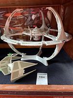 Deep Space 9 space station model on stand with Star Wars TIE Fighter model in front