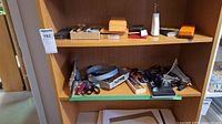 Wide shot showing shelves with various model building tools including clamps, knives, and files.