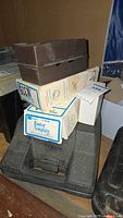 Stacked boxes including Sears Craftsman Router Template box and brown plastic bit case on a black carrying case