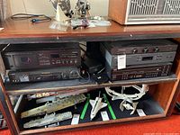 Overall shelf view of mid and bottom shelves, mid shelf holding Sony, Yamaha, NAD and ADCOM components