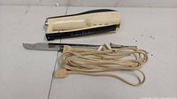 Vintage Eastern Electric handheld kitchen cutting tool with attached power cord and blade