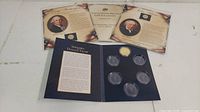 Overview of the presidential collectable coin set with informational cards and multiple coins in protective plastic holders.
