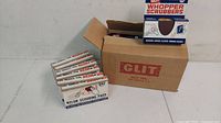 Multiple boxes of GLIT nylon scouring pads and Whopper scrubbers with one box open