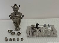 Full view of the miniature samovar set, including samovar, cups, thimbles, salt & pepper shakers on copper tray