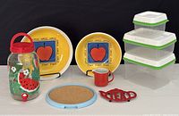 Lot overview shows all items including two Italian apple serving dishes, watermelon glass drink dispenser, blue rim cork tray, trio of Rubbermaid containers, red metal trivet and small red milk server.