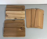 Top view of all nine cedar planks showing branded text and wood grain details.