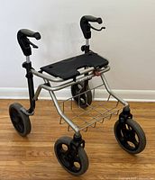 Front angle view showing aluminum frame, large wheels and under-seat wire basket