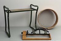 Full lot showing gardening seat, soil sieve and lawn sprinkler.