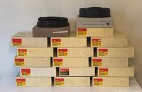 Stack of Kodak slide carousels in original boxes, predominantly 140 slide capacity carousels, neatly stacked and labelled Kodak Carousel Tray images.