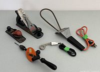 Two metal hand planes, one Stanley No. 4, one no-name smaller plane; two immersion heaters, one Temro brand; and Scroder hand drill with orange handle and attached drill bit.