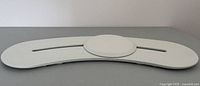 White curved slider transfer board with a central circular sliding disc, top view showing whole board and disc.