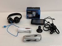 Overall lot including all electronic items and accessories displayed on a white surface
