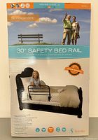 Front side of the box showing the 30" Safety Bed Rail with a person sitting on the bed rail and a picture of an elderly couple on a bench.